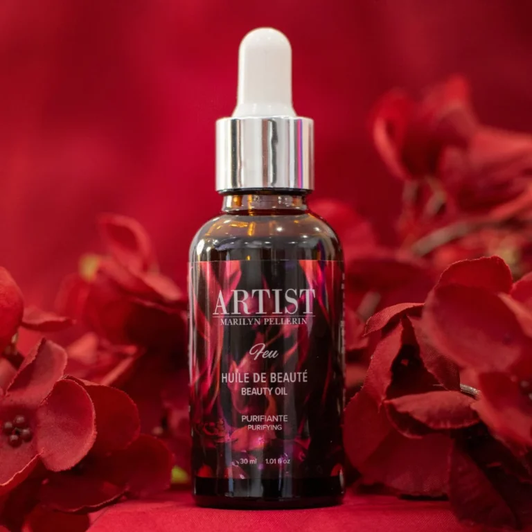Huile de beauté ARTIST sur fond de fleurs rouges