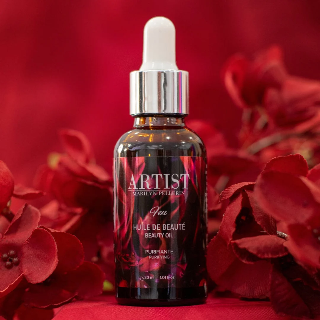 Huile de beauté ARTIST sur fond de fleurs rouges